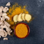 set-ginger-slices-powder-ginger-bowl-dark-textured-background-top-view-space-text
